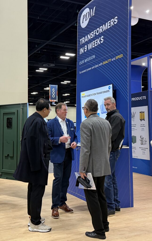 Jake Ring with Clients a Booth